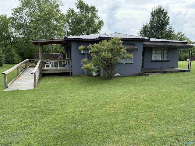 4094 County Road 66, Section, AL 35771 - rear view of property featuring concrete block siding, a yard, metal roof, and a deck
