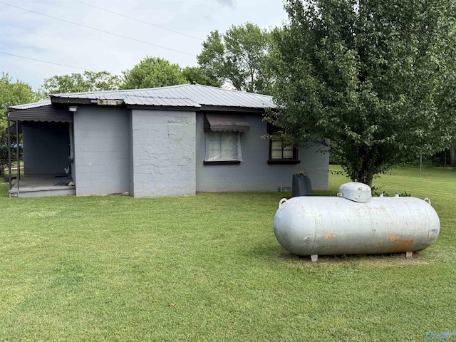 4094 County Road 66, Section, AL 35771 - view of side of home featuring concrete block siding, a lawn, and metal roof