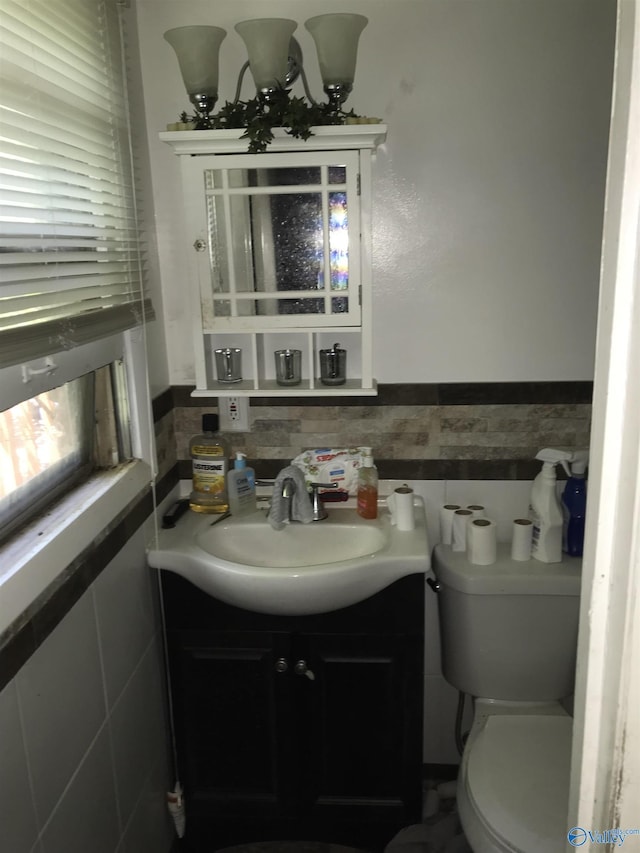 3411 Euclid Dr NW, Huntsville, AL 35810 - half bath with tile walls, vanity, a wainscoted wall, and toilet