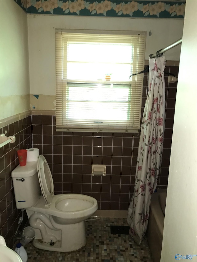 3411 Euclid Dr NW, Huntsville, AL 35810 - bathroom with toilet, tile walls, plenty of natural light, shower / bath combo, and a wainscoted wall