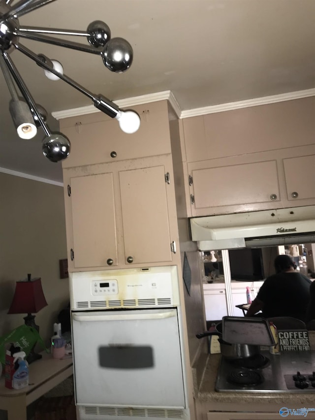 3411 Euclid Dr NW, Huntsville, AL 35810 - kitchen featuring white oven, stovetop, ornamental molding, white cabinetry, and ventilation hood