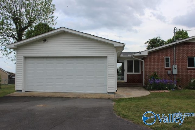 view of front of property with a garage and a front lawn