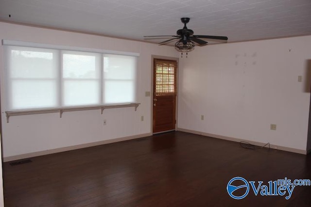 empty room featuring dark wood-type flooring and ceiling fan