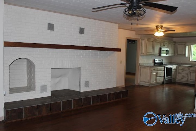 kitchen featuring dark hardwood / wood-style flooring, ceiling fan, brick wall, and appliances with stainless steel finishes