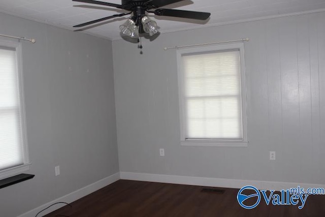 spare room with dark hardwood / wood-style floors and ceiling fan