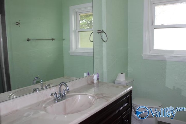 bathroom featuring vanity and toilet