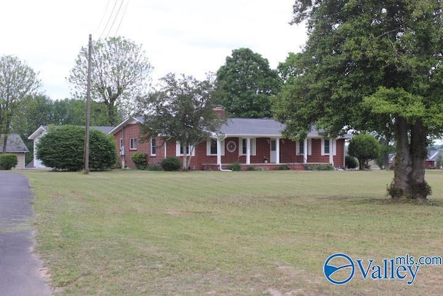 ranch-style home featuring a porch and a front lawn