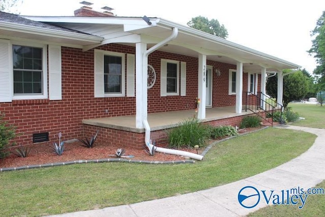 view of side of property featuring a porch and a yard