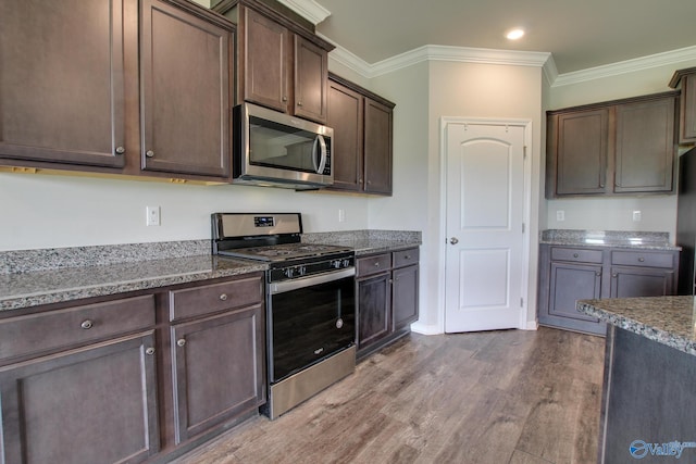 13971 Lannister Ln, Athens, AL 35613 - kitchen with stainless steel appliances, dark brown cabinets, stone countertops, wood finished floors, and ornamental molding