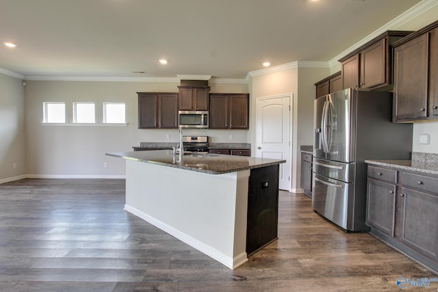 13971 Lannister Ln, Athens, AL 35613 - kitchen featuring appliances with stainless steel finishes, dark brown cabinets, a center island with sink, dark stone counters, and crown molding