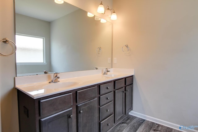 13971 Lannister Ln, Athens, AL 35613 - bathroom featuring wood finished floors, double vanity, and baseboards