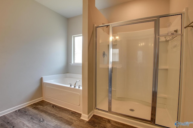 13971 Lannister Ln, Athens, AL 35613 - full bathroom with wood finished floors, a stall shower, a bath, and baseboards