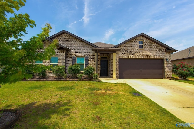 13971 Lannister Ln, Athens, AL 35613 - view of front of property with brick siding, concrete driveway, a front lawn, and a garage