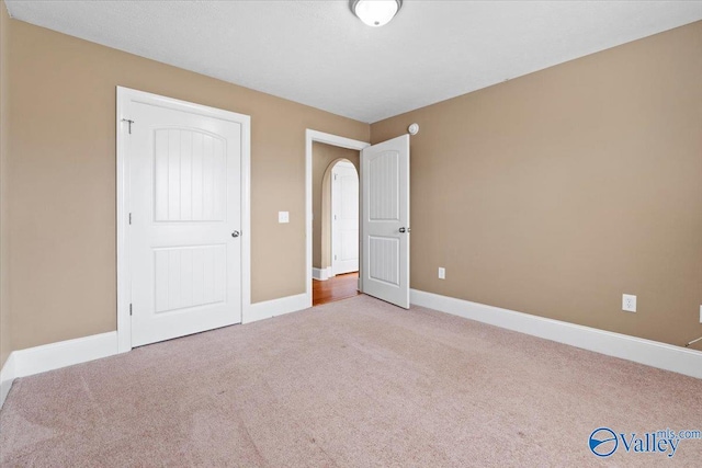 unfurnished bedroom with light carpet