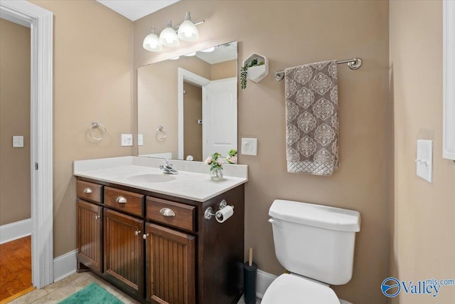 bathroom with tile patterned floors, vanity, and toilet