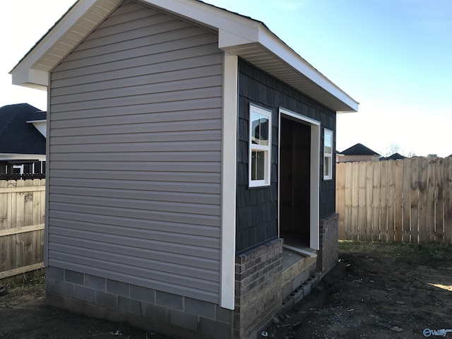 view of home's exterior with an outbuilding