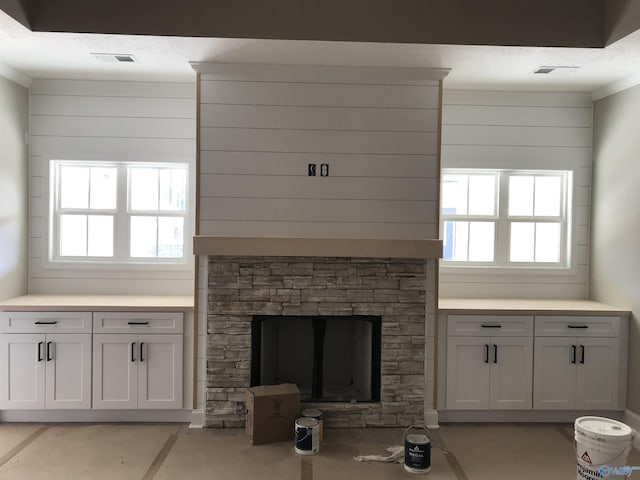 unfurnished living room featuring a stone fireplace