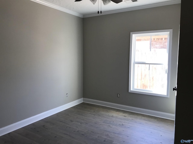 empty room featuring crown molding, ceiling fan, and dark wood-type flooring