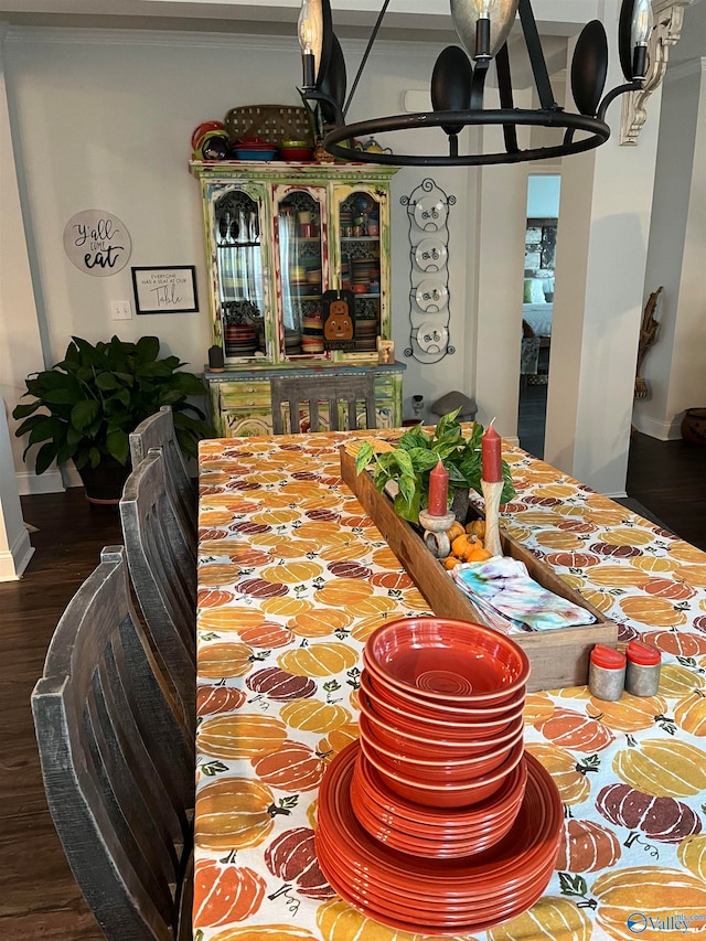 dining space with an inviting chandelier and hardwood / wood-style flooring