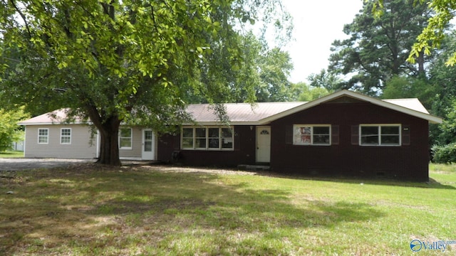 ranch-style house with metal roof and a front lawn