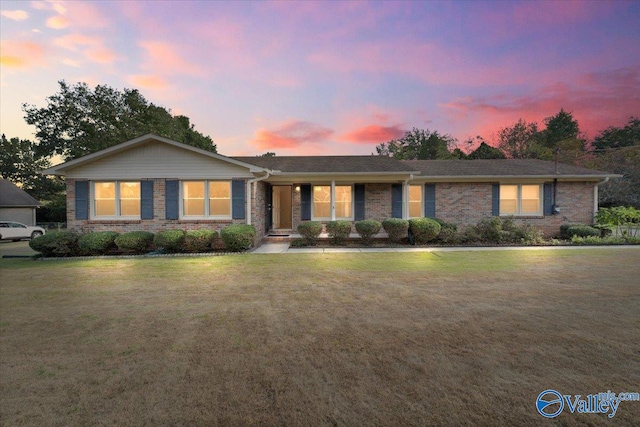 ranch-style house featuring a yard