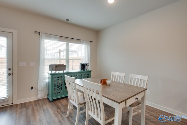 dining space with hardwood / wood-style flooring and a healthy amount of sunlight