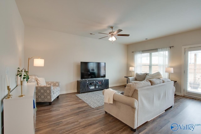 living room with ceiling fan and dark hardwood / wood-style flooring