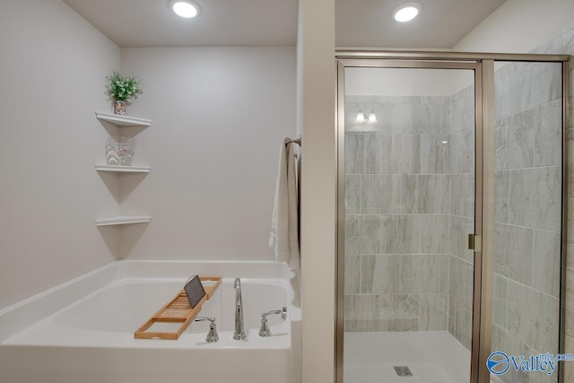 bathroom with separate shower and tub