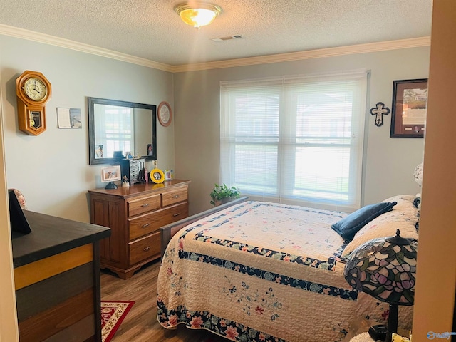 bedroom featuring wood-type flooring, a textured ceiling, ornamental molding, and multiple windows