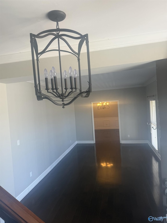 details featuring crown molding, baseboards, and wood finished floors