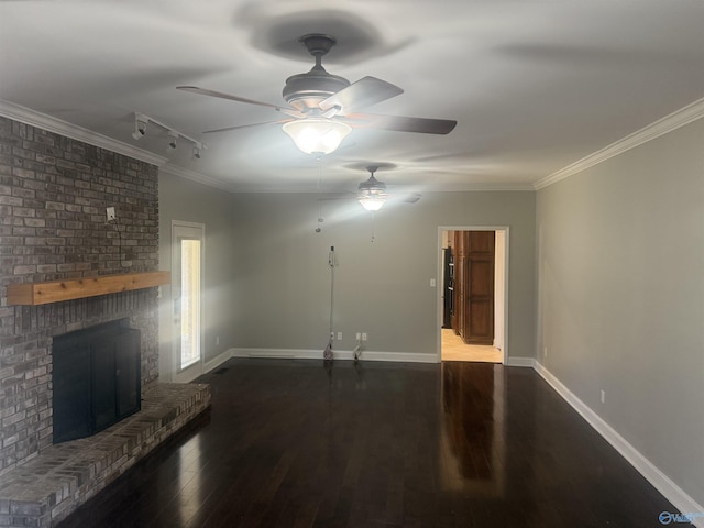 unfurnished living room featuring dark wood-style floors, a fireplace, baseboards, and crown molding