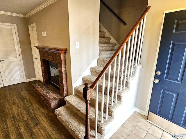 interior space featuring crown molding, wood-type flooring, and a fireplace