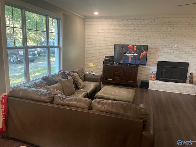 living room with brick wall and dark hardwood / wood-style floors