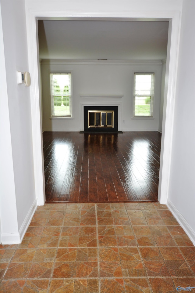 310 Drury Ln, Huntsville, AL 35802 - unfurnished living room featuring healthy amount of natural light, a fireplace with flush hearth, and wood-type flooring