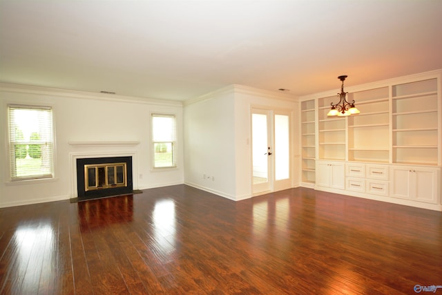 310 Drury Ln, Huntsville, AL 35802 - unfurnished living room with a glass covered fireplace, a chandelier, plenty of natural light, dark wood finished floors, and crown molding