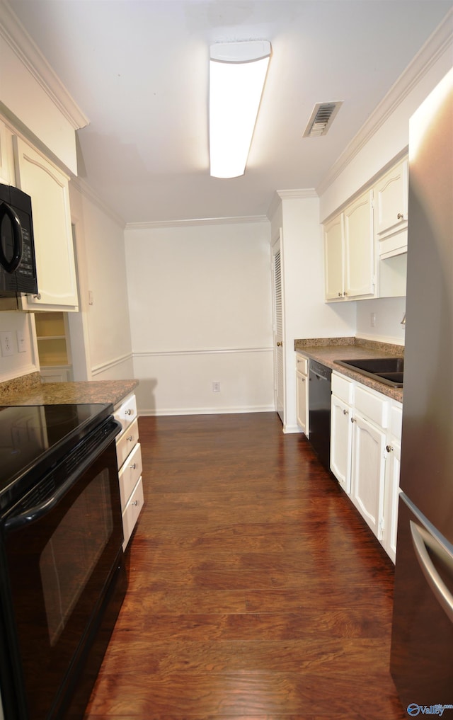 310 Drury Ln, Huntsville, AL 35802 - kitchen featuring black appliances, dark wood-type flooring, ornamental molding, and white cabinetry
