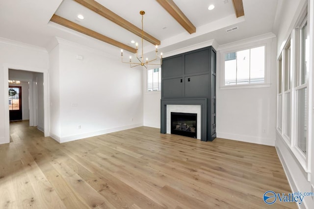 unfurnished living room with beam ceiling, a fireplace, light wood-style flooring, and baseboards