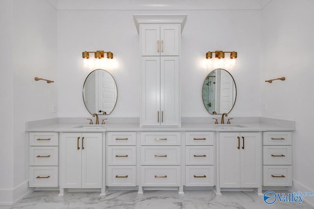 full bathroom with marble finish floor, a sink, and double vanity