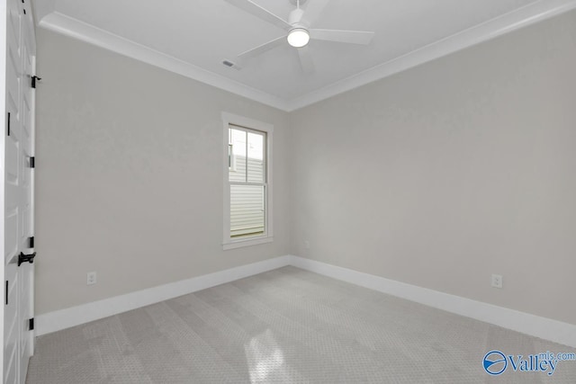 spare room featuring light carpet, visible vents, baseboards, ceiling fan, and crown molding