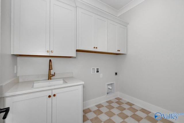 washroom with washer hookup, cabinet space, hookup for an electric dryer, a sink, and baseboards