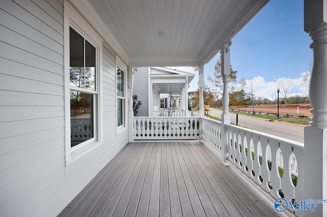 wooden terrace featuring covered porch