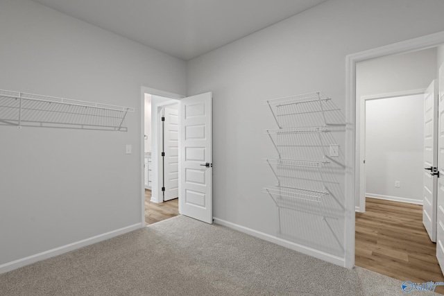 walk in closet featuring light hardwood / wood-style floors