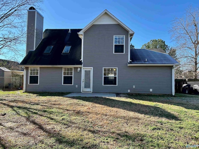 rear view of property featuring a patio area and a lawn