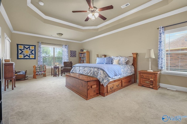 bedroom with a raised ceiling, crown molding, light carpet, and ceiling fan