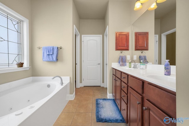 bathroom with vanity, a tub, and tile patterned floors