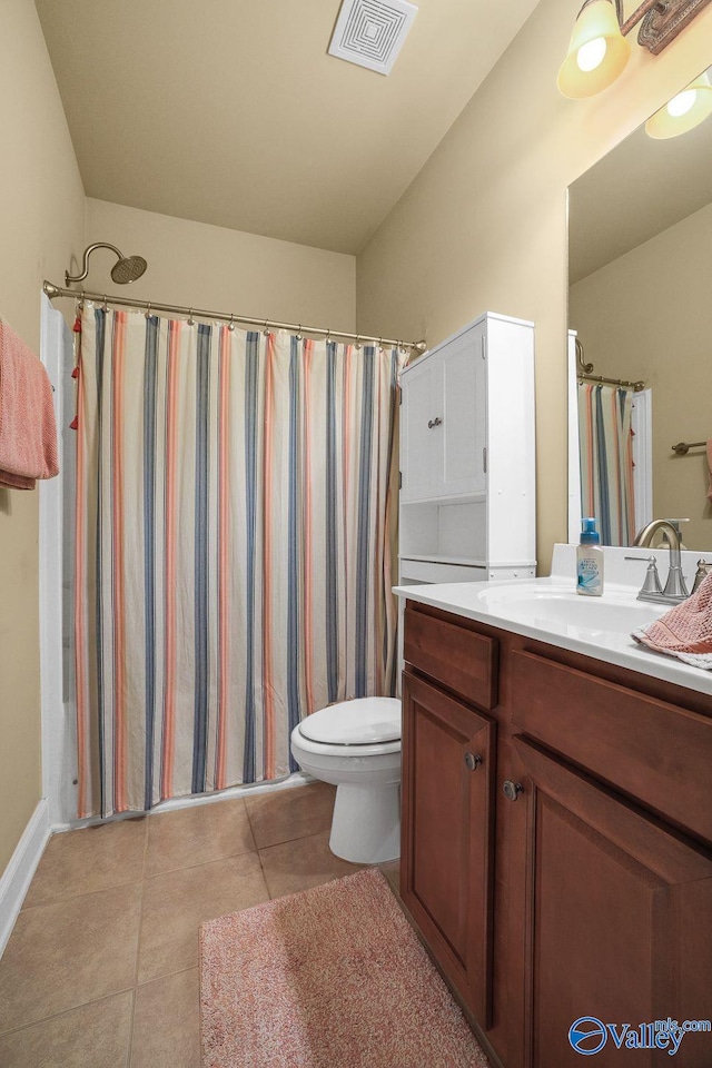 bathroom with a shower with curtain, vanity, tile patterned floors, and toilet