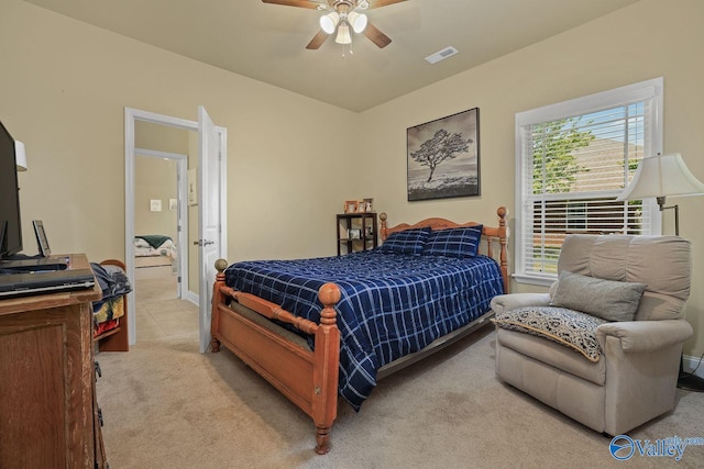 bedroom featuring multiple windows, light carpet, and ceiling fan