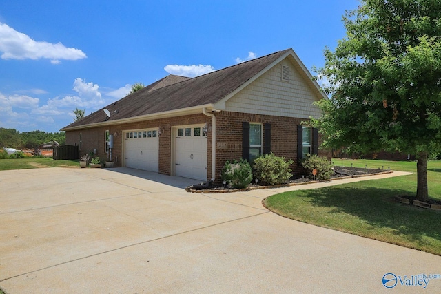 view of home's exterior with a garage and a yard