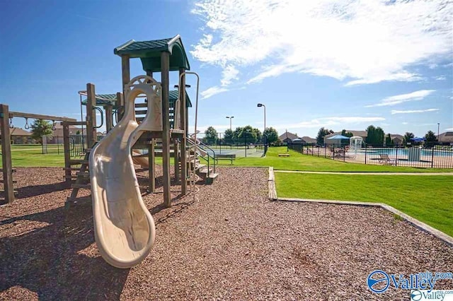 view of playground with a lawn