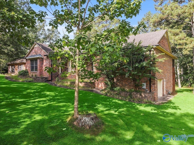 view of front of home featuring a front yard and brick siding